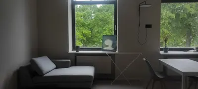 a room with a chair and a desk and a window at VEPA in Vepriai