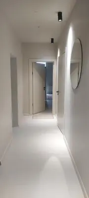 an empty room with a mirror and a hallway at VEPA in Vepriai