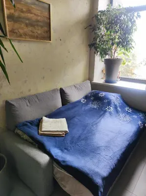 a blue blanket sitting on a couch in a room at VEPA in Vepriai