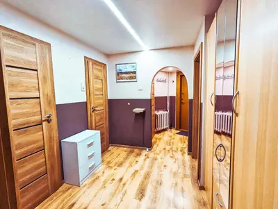 a room with wooden floors and a hallway with doors at Apartment for a short rent in KaunasButas trumpalaikei nuomai Kaune in Kaunas
