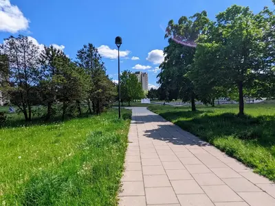 a path in a park with trees and a street light at Apartment for a short rent in KaunasButas trumpalaikei nuomai Kaune in Kaunas
