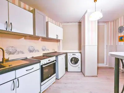 a kitchen with white cabinets and a washer and dryer at Apartment for a short rent in KaunasButas trumpalaikei nuomai Kaune in Kaunas