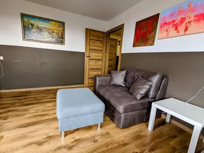a living room with a couch and a table at Apartment for a short rent in KaunasButas trumpalaikei nuomai Kaune in Kaunas