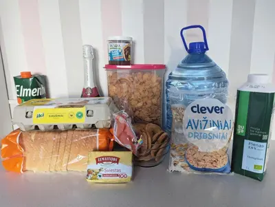 a counter top with food and a bottle of water at Apartment for a short rent in KaunasButas trumpalaikei nuomai Kaune in Kaunas