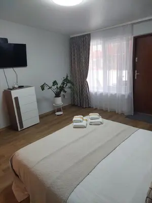 a bedroom with a bed with two towels on it at Lapių Ola in Utena