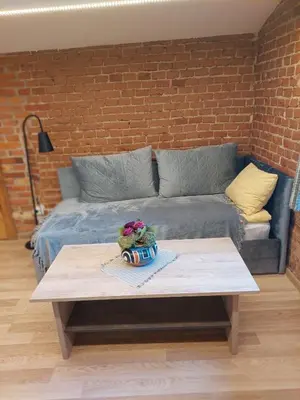 a coffee table in a living room with a couch at Lapių Ola in Utena