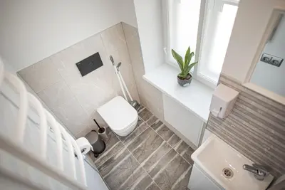 a small bathroom with a toilet and a sink at Lapių Ola in Utena