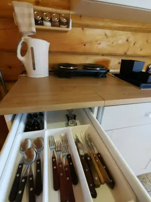 a drawer filled with utensils on a table at Sodyba 