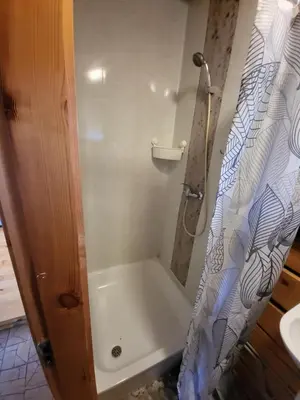a bathroom with a shower with a shower curtain at Sodyba 