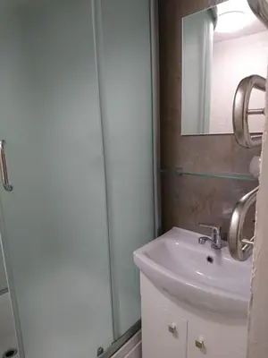 a bathroom with a sink and a shower at Link Kauno marių... in Kaunas