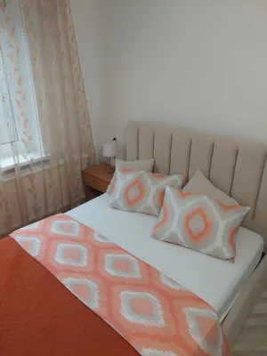 a bed with two pillows on top of it at Link Kauno marių... in Kaunas