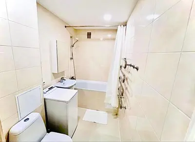a bathroom with a toilet and a sink and a tub at M&M Apartment VI SELF CHECK-IN in Panevėžys