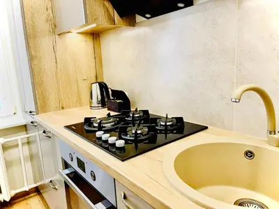 a kitchen with a stove and a sink at M&M Apartment VI SELF CHECK-IN in Panevėžys