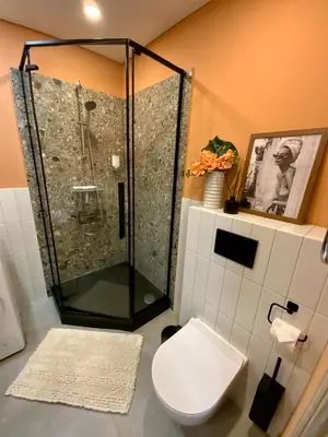 a bathroom with a shower and a toilet at Alėjos Apartmentai City in Druskininkai