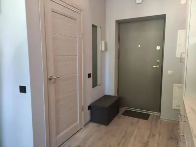 a hallway with a door and a stool in a room at Cosy Apartments in Vilnius Center in Vilnius