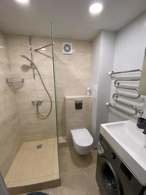 a bathroom with a shower and a toilet and a sink at ADI Apartamentai in Panevėžys