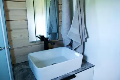 a bathroom with a white sink and a mirror at Chill House in Miežonys