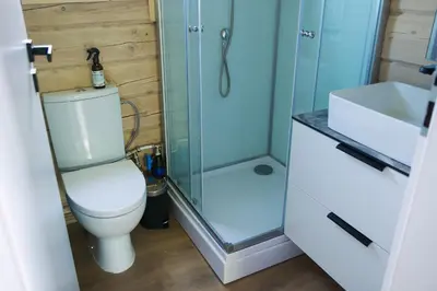 a bathroom with a shower and a toilet and a sink at Chill House in Miežonys