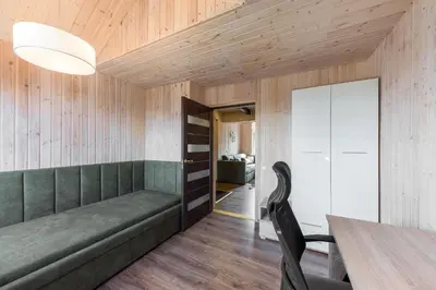a dining room with a couch and a table at Shanghai Banzai Family Apartment Vilnius in Vilnius