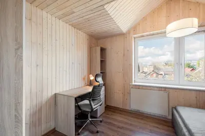 a small room with a desk and a window at Shanghai Banzai Family Apartment Vilnius in Vilnius