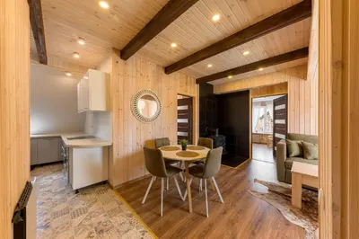 a kitchen and dining room with a table and chairs at Shanghai Banzai Family Apartment Vilnius in Vilnius