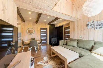 a living room with a couch and a table at Shanghai Banzai Family Apartment Vilnius in Vilnius