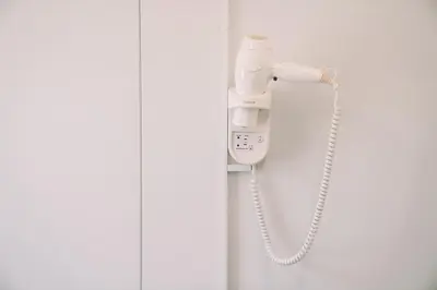 a phone hanging on a wall in a bathroom at Natur Camp Glamping Birštonas in Birštonas
