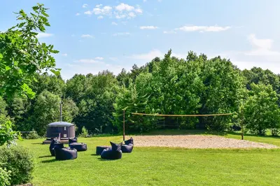 a park with a playground with a yellow rope at Sodyba Pivašiūnuose ant ežero kranto in Pivašiūnai