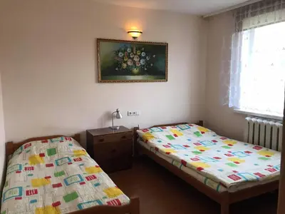 a bedroom with two beds and a picture on the wall at Rooms for Rent near Vilnius in Bezdonys