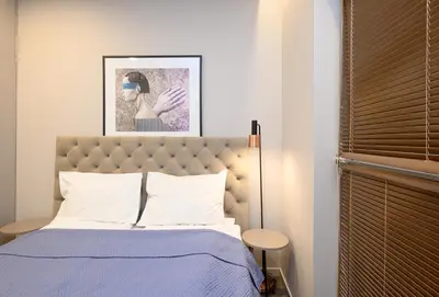 a bedroom with a bed with a blue comforter at Apartment w-Terrace I Air Condition I New building I Self Check-In in Birštonas