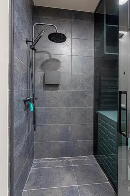 a shower with a glass door in a bathroom at Apartment w-Terrace I Air Condition I New building I Self Check-In in Birštonas