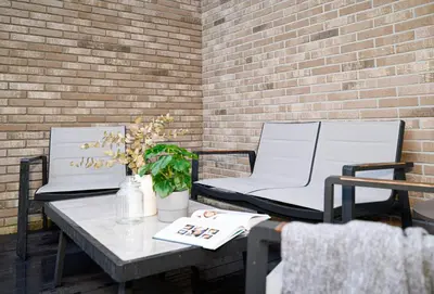 two chairs and a table on a patio at Apartment w-Terrace I Air Condition I New building I Self Check-In in Birštonas