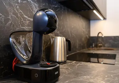 a coffee maker sitting on top of a kitchen counter at Apartment w-Terrace I Air Condition I New building I Self Check-In in Birštonas