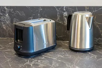 a toaster andrower sitting on a kitchen counter at Apartment w-Terrace I Air Condition I New building I Self Check-In in Birštonas