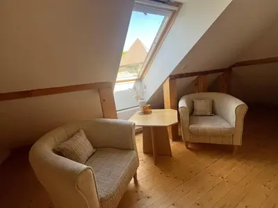 a living room with two chairs and a table at In heart of Trakai you'll find authentic Karaim house in Trakai