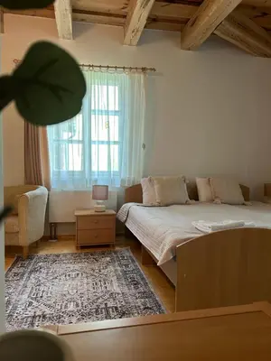 a bedroom with a bed and a large window at In heart of Trakai you'll find authentic Karaim house in Trakai