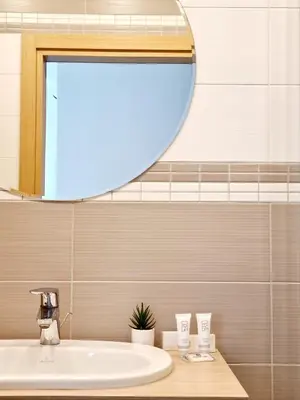 a bathroom with a sink and a mirror at MELODIJA apartments in Druskininkai center in Druskininkai
