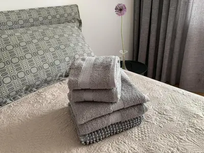 a pile of towels sitting on top of a bed at Sonatina apartment in Druskininkai