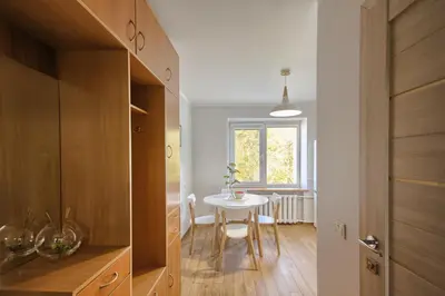 a kitchen with a table and a dining room at Sonatina apartment in Druskininkai