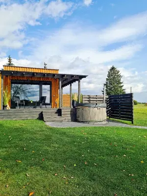 a gazebo with a table and chairs in a field at Volunge house in Doškonys