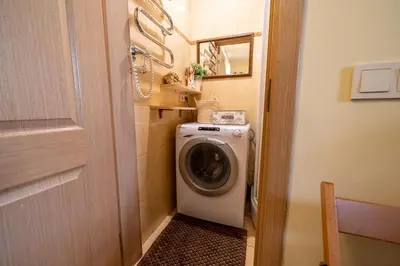 a washer and dryer in a small bathroom at Cozy Suite with Inner Yard in Vilnius