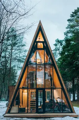 a small house with a triangular roof with windows at Trikampis MIŠKO NAMELIS Druskininkų centre in Druskininkai