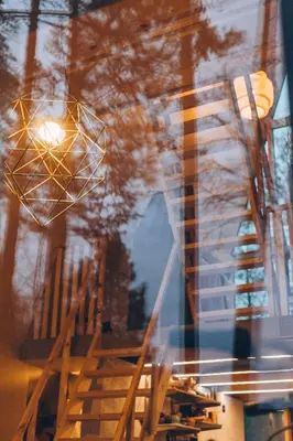 a reflection of a building in a window at Trikampis MIŠKO NAMELIS Druskininkų centre in Druskininkai