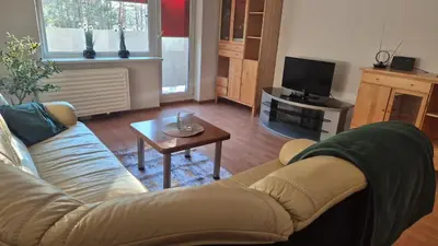a living room with a couch and a coffee table at Alka Lake Inn in Druskininkai
