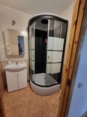 a small bathroom with a shower and a sink at Alka Lake Inn in Druskininkai