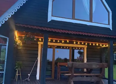 a porch with a bench and lights on it at Sodyba Anykščių raj. in Anykščiai