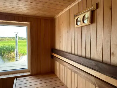 a room with a window in a wooden cabin at Sodyba Anykščių raj. in Anykščiai