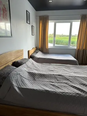 two beds in a room with a window at Sodyba Anykščių raj. in Anykščiai