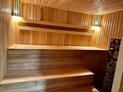 a sauna with wooden walls and wooden shelves at Sodyba Anykščių raj. in Anykščiai