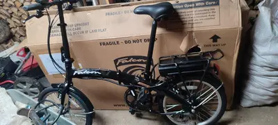 a bike is parked next to a box at Saulėtekio 12 in Ignalina